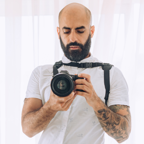 Photographer Joseph Singh holding a camera