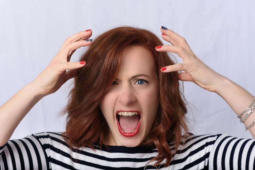 Female with ADHD showing a frustrated but positive facial expression