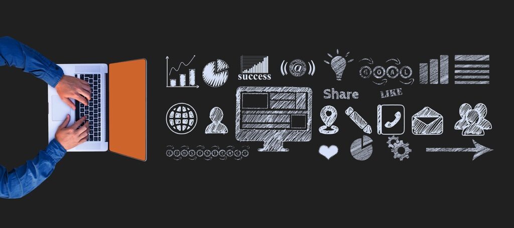 Website marketing strategy - laptop with icons on a blackboard
