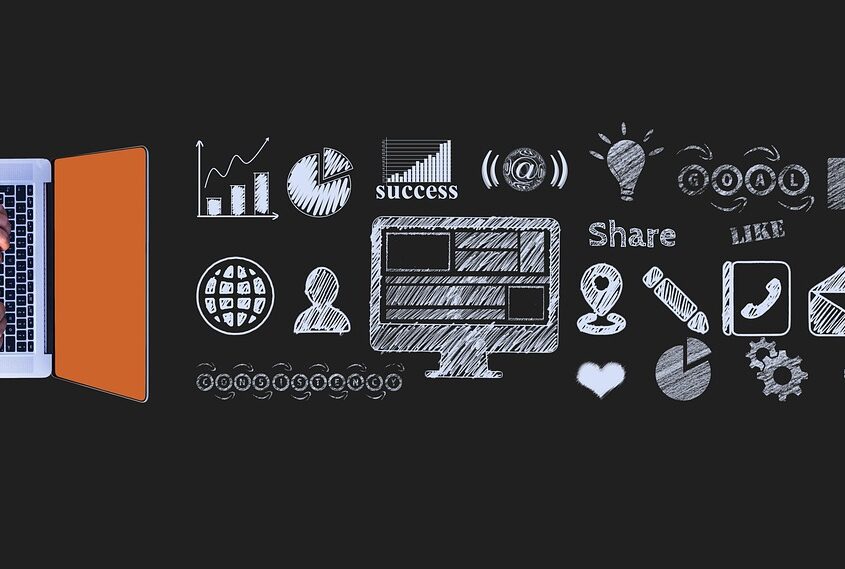 Website marketing strategy - laptop with icons on a blackboard